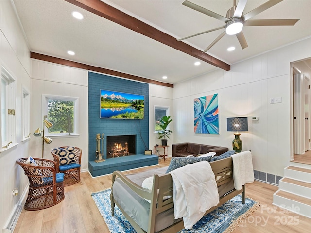 1278 Island Creek Dr, Troy, NC 27371 - living room featuring ceiling fan, a brick fireplace, wood finished floors, and visible vents