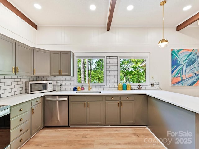 1278 Island Creek Dr, Troy, NC 27371 - kitchen featuring a sink, decorative backsplash, gray cabinets, beamed ceiling, and appliances with stainless steel finishes