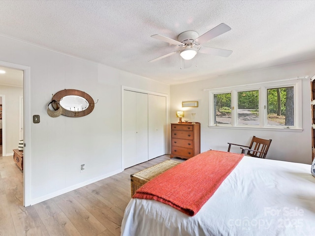 1278 Island Creek Dr, Troy, NC 27371 - bedroom featuring a closet, wood finished floors, a textured ceiling, and a ceiling fan