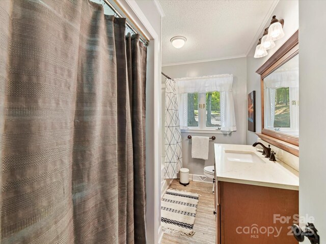 1278 Island Creek Dr, Troy, NC 27371 - full bathroom featuring a textured ceiling, toilet, wood finished floors, crown molding, and vanity