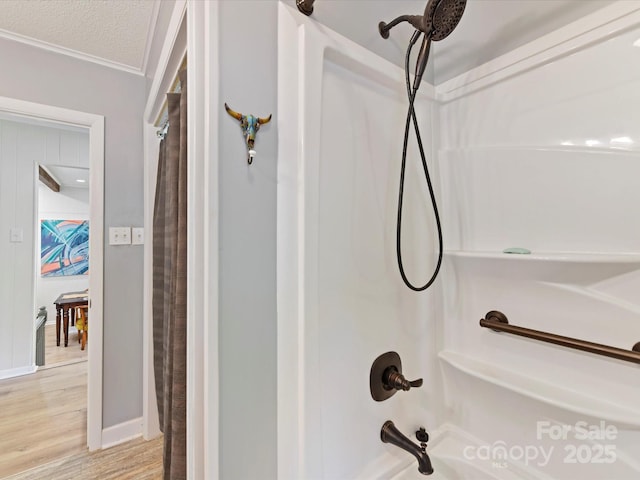 1278 Island Creek Dr, Troy, NC 27371 - full bath featuring wood finished floors, a textured ceiling, baseboards, and shower / bathtub combination with curtain