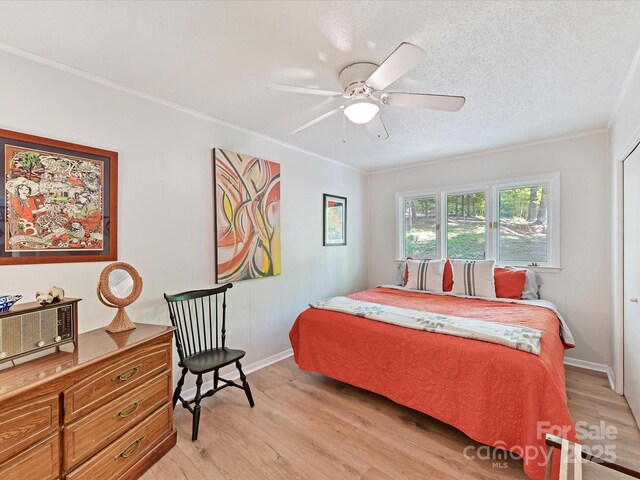 1278 Island Creek Dr, Troy, NC 27371 - bedroom featuring light wood finished floors, ornamental molding, baseboards, a textured ceiling, and ceiling fan