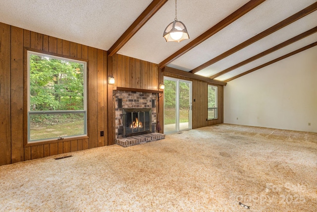 6 N Hudson Ln, Fletcher, NC 28732 - unfurnished living room with carpet, a brick fireplace, wood walls, plenty of natural light, and a textured ceiling