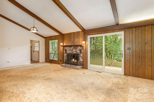 6 N Hudson Ln, Fletcher, NC 28732 - unfurnished living room featuring carpet floors, wood walls, plenty of natural light, and a fireplace
