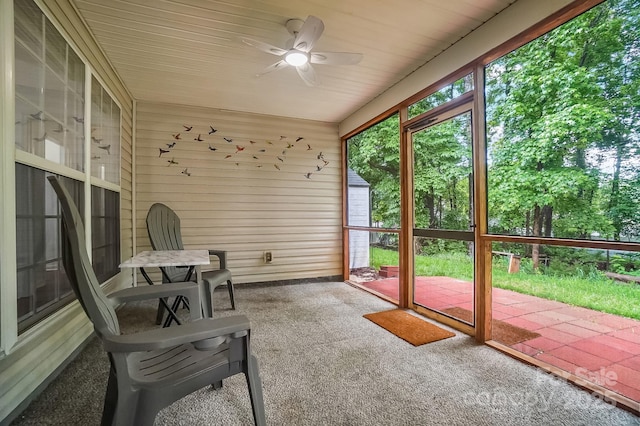 unfurnished sunroom with ceiling fan