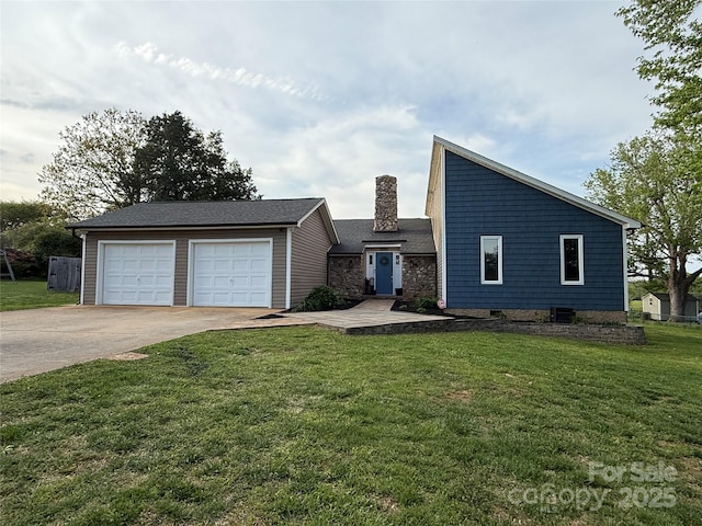 mid-century modern home featuring a front lawn, a chimney, an outbuilding, and a garage