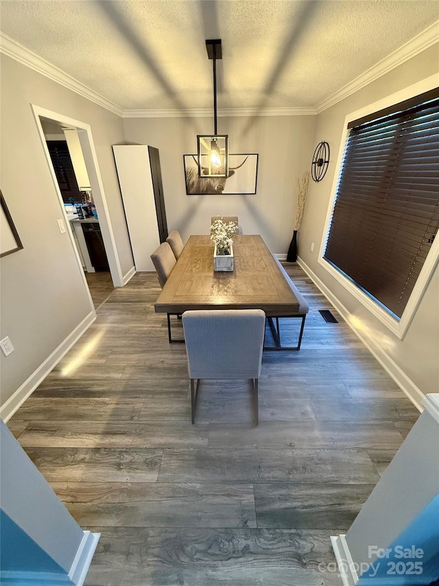 dining area featuring baseboards, a textured ceiling, and dark wood-type flooring