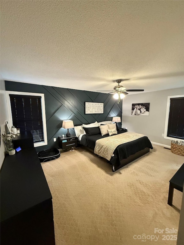 bedroom featuring carpet floors, a textured ceiling, and a ceiling fan