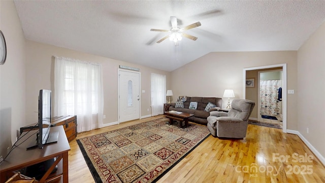 3124 Banks St, Lincolnton, NC 28092 - living room featuring a ceiling fan, wood finished floors, vaulted ceiling, baseboards, and a textured ceiling