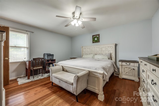 bedroom featuring baseboards, a ceiling fan, and dark wood-style floors