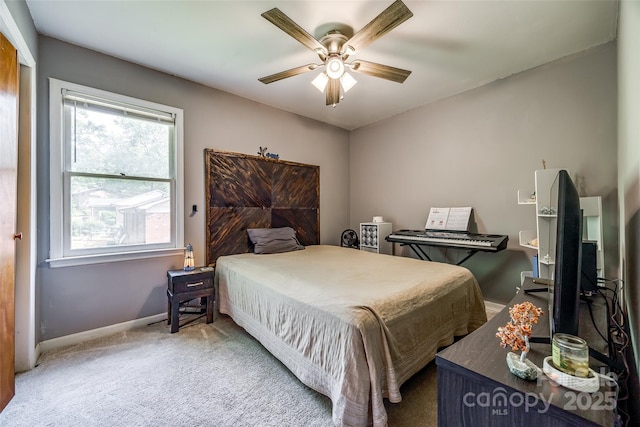 carpeted bedroom featuring ceiling fan and baseboards