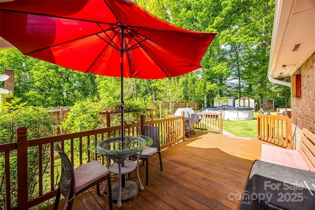 wooden terrace with a fenced backyard and a fenced in pool