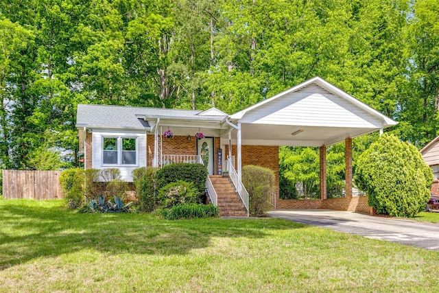 view of front of property featuring stairway, concrete driveway, a front lawn, an attached carport, and brick siding