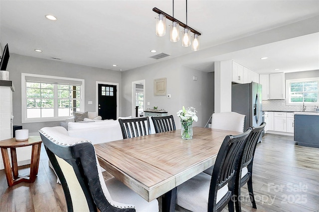 dining space with recessed lighting, visible vents, and light wood-style floors
