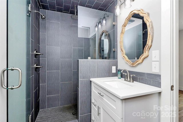 bathroom with vanity and a stall shower