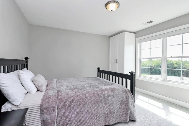 carpeted bedroom with baseboards and visible vents