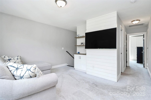 living room with baseboards, light colored carpet, and visible vents