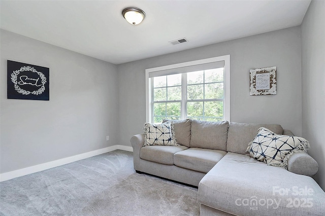 living area with visible vents, baseboards, and carpet floors