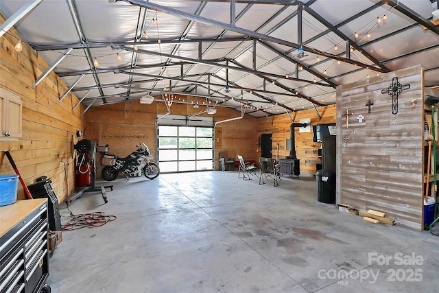 garage featuring wood walls and a garage door opener