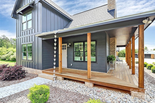 property entrance with board and batten siding and a porch