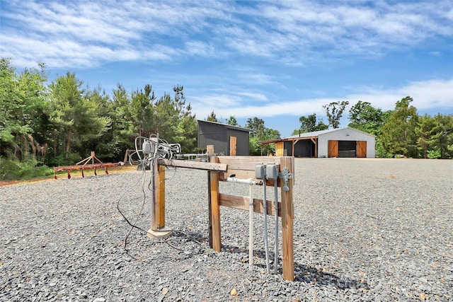 exterior space with a pole building and gravel driveway
