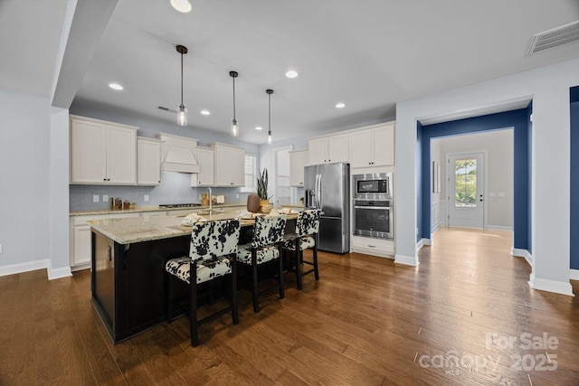 kitchen featuring white cabinetry, baseboards, appliances with stainless steel finishes, and visible vents