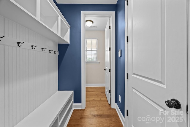 mudroom with baseboards and wood finished floors