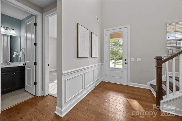 entrance foyer with hardwood / wood-style floors and stairs