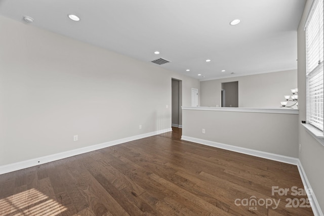spare room featuring baseboards, wood finished floors, visible vents, and recessed lighting