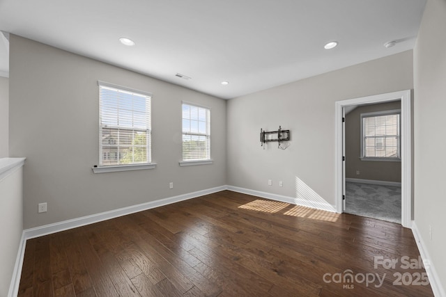 spare room featuring visible vents, hardwood / wood-style flooring, baseboards, and recessed lighting