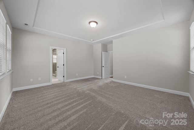 unfurnished bedroom featuring baseboards, visible vents, carpet, and connected bathroom