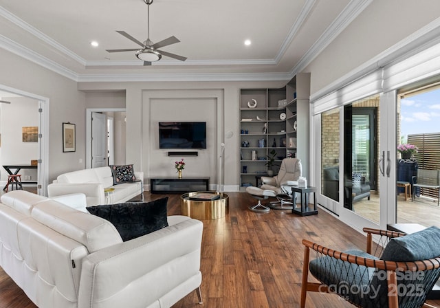 767 Pinnacle Dr, Iron Station, NC 28080 - living room with ornamental molding, built in features, ceiling fan, and wood finished floors