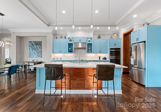 767 Pinnacle Dr, Iron Station, NC 28080 - kitchen featuring light countertops, stainless steel appliances, a kitchen bar, and blue cabinets