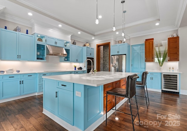 767 Pinnacle Dr, Iron Station, NC 28080 - kitchen featuring a breakfast bar area, wine cooler, under cabinet range hood, stainless steel refrigerator with ice dispenser, and blue cabinets