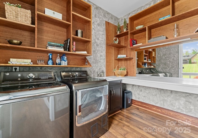 767 Pinnacle Dr, Iron Station, NC 28080 - laundry room featuring cabinet space, wallpapered walls, light wood-style flooring, and washer and dryer