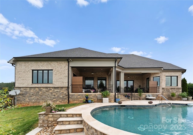 767 Pinnacle Dr, Iron Station, NC 28080 - rear view of property with brick siding, a shingled roof, an outdoor pool, and stone siding
