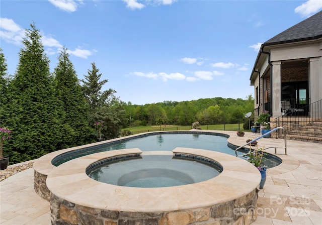 767 Pinnacle Dr, Iron Station, NC 28080 - pool featuring a patio, an in ground hot tub, fence, and a wooded view