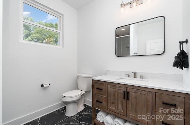 bathroom featuring a shower with shower door, baseboards, vanity, toilet, and marble finish floor