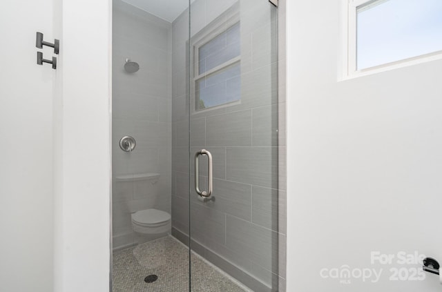 full bathroom with a stall shower and toilet