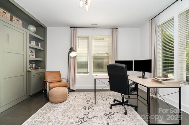 office space featuring baseboards and plenty of natural light