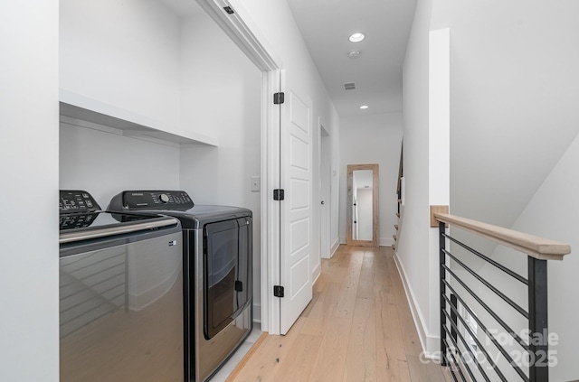 laundry area with laundry area, light wood-style floors, baseboards, recessed lighting, and washer and clothes dryer