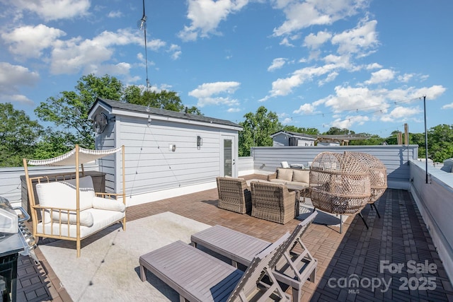 view of patio featuring an outdoor hangout area, fence, and an outdoor structure