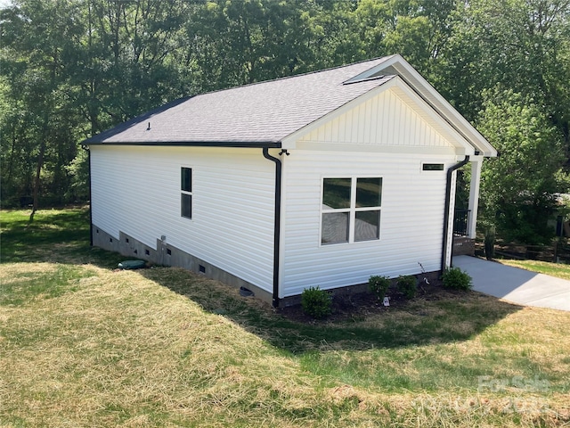 view of property exterior with crawl space, roof with shingles, and a yard
