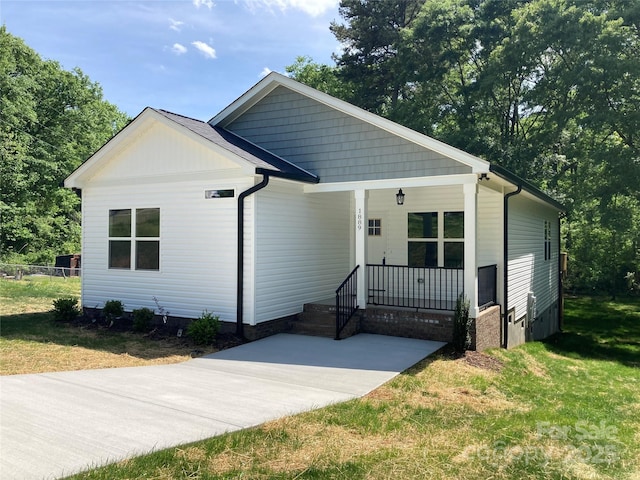 bungalow-style home with a porch and a front lawn