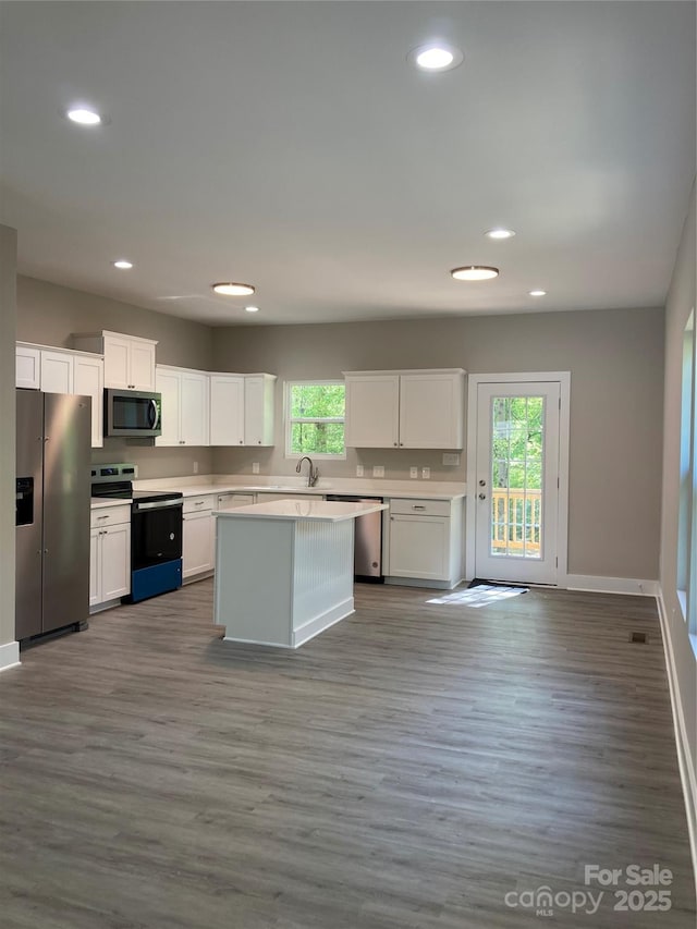 kitchen featuring a sink, light countertops, white cabinets, appliances with stainless steel finishes, and recessed lighting