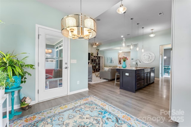 2124 Katie Alice Cir, Waxhaw, NC 28173 - kitchen with open floor plan, a chandelier, wood finished floors, stainless steel dishwasher, and pendant lighting