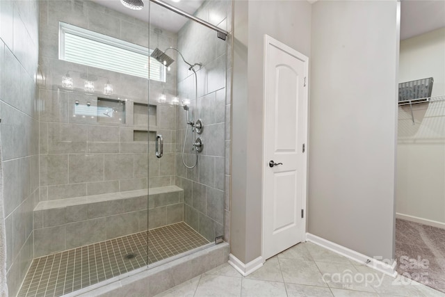 2124 Katie Alice Cir, Waxhaw, NC 28173 - bathroom with a shower stall, tile patterned floors, baseboards, and a spacious closet
