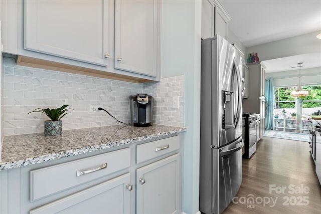 2124 Katie Alice Cir, Waxhaw, NC 28173 - kitchen featuring appliances with stainless steel finishes, light stone countertops, backsplash, dark wood-style flooring, and pendant lighting
