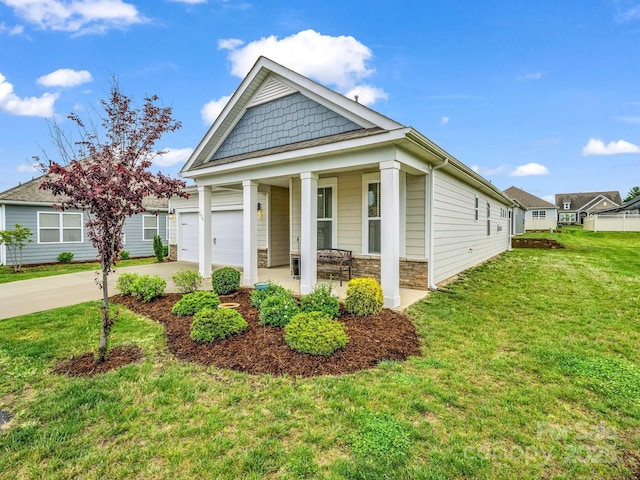 775 Summerfield Pl, Flat Rock, NC 28731 - view of front of property featuring a front lawn, stone siding, concrete driveway, covered porch, and an attached garage