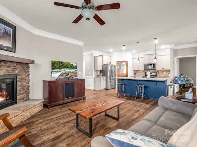 775 Summerfield Pl, Flat Rock, NC 28731 - living area featuring crown molding, a stone fireplace, a ceiling fan, and wood finished floors
